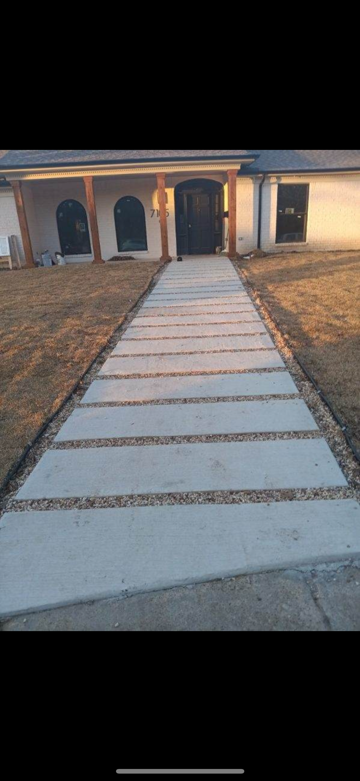 Tiered concrete block retaining wall with landscaping